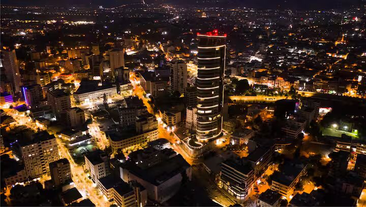 The 360 Nicosia tower lit up at night above the old city